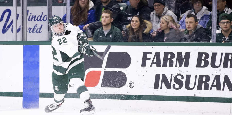 MSU+defenseman+Dennis+Cesana+redirects+the+puck+out+of+the+corner%2F+Photo+Credit%3A+MSU+Athletic+Communications+