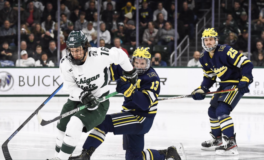 MSU F Brody Stevens battles for a puck against Michigan/ Photo Credit: MSU Athletic Communications