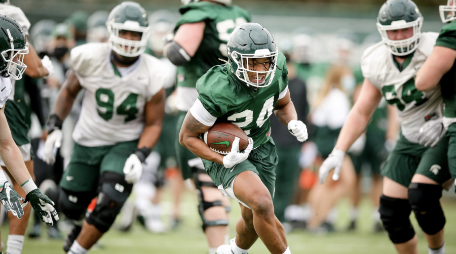 MSU+running+back+Elijah+Collins+runs+through+a+hole+during+spring+practice%2F+Photo+Credit%3A+MSU+Athletic+Communications%0A%0A%0A