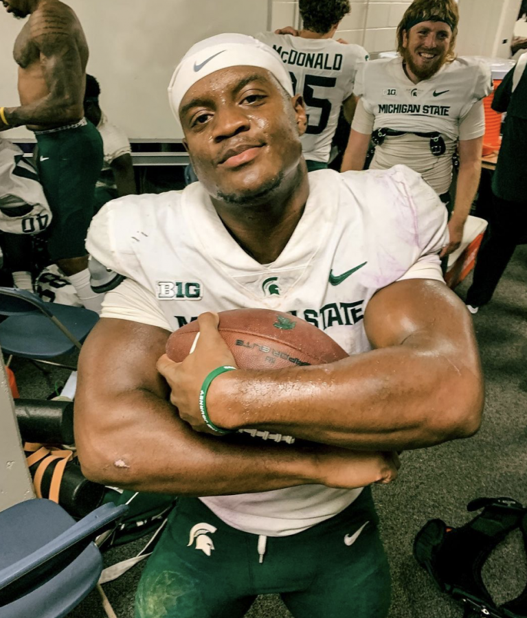 MSU running back Kenneth Walker holds the game ball after rushing for 264 yards and four touchdowns against Northwestern on Sept. 3, 2021/ Photo Credit: MSU Athletic Communications 