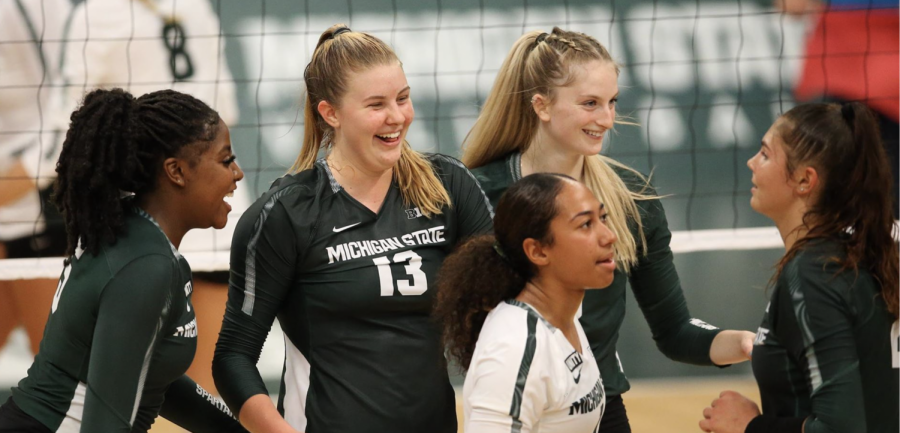 MSU outside hitter Sarah Franklin (13) smiles wit her teammates during a game/ Photo Credit: MSU Athletic Communications 