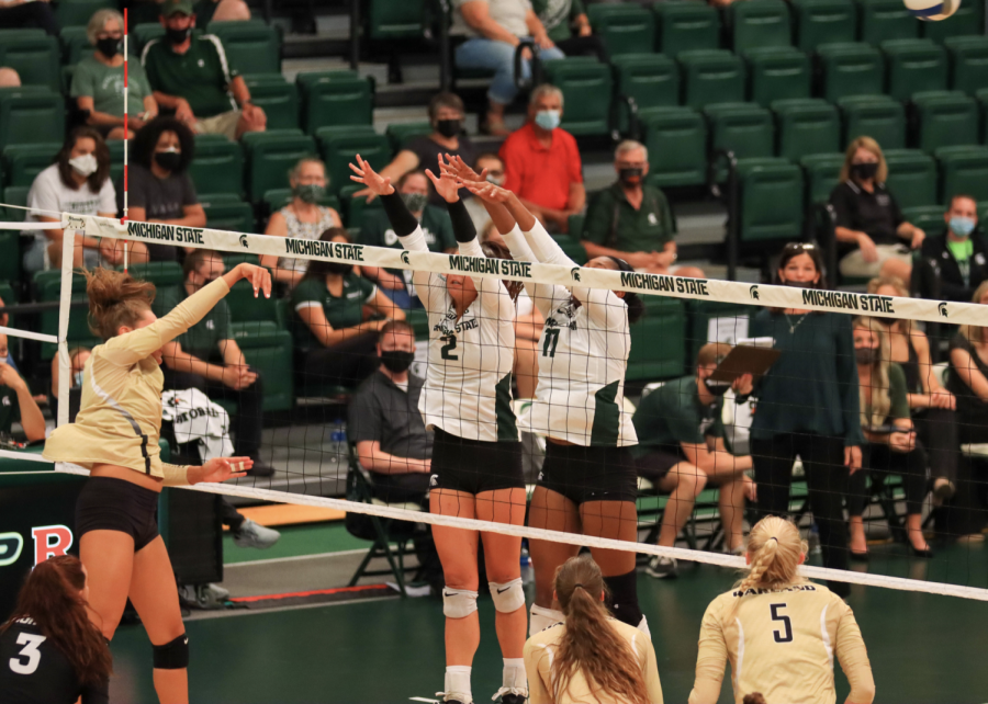 MSU+setter+Celia+Cullen+%282%29+and+middle+blocker+Naya+Gros+%2817%29+guard+the+front+of+the+net+in+MSUs+win+over+Oakland+in+September+of+2021%2F+Photo+Credit%3A+Sarah+Smith%2FWDBM
