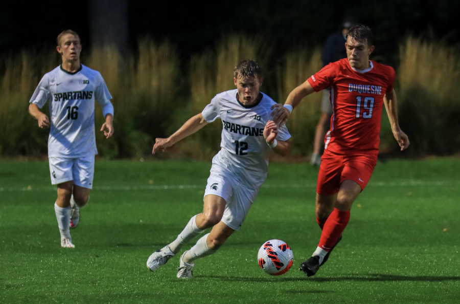 MSU defender Nick Stone attempts to keep the ball away from Duquesne forward Zack Mowka (19) in the Spartans 1-0 win on Sept. 21, 2021/ Photo Credit: Sarah Smith/WDBM