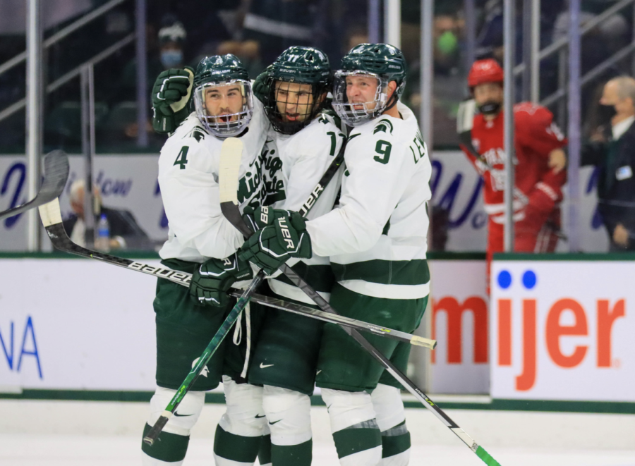 MSU forward Jeremy Davidson (11) gets congratulated by defenseman Nash Nienhius (4) and forward Mitchell Lewandowski (9) after scoring a goal in the Spartans 3-1 win over Miami (OH) on Oct. 15, 2021/ Photo Credit: Sarah Smith/WDBM