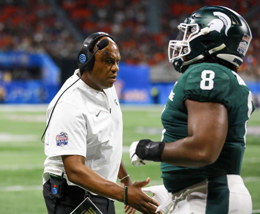 MSU head coach Mel Tucker high-fives defensive tackle Simeon Barrow during the Spartans 31-21 Peach Bowl victory over Pittsburgh on Dec. 30, 2021/ Photo Credit: Sarah Smith/WDBM