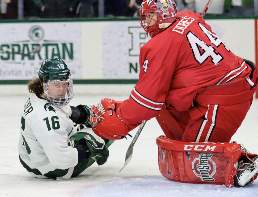 MSU+forward+Jesse+Tucker+falls+to+the+ice+in+front+of+Ohio+State+goaltender+Jakub+Dobes+on+Jan.+22%2C+2022%2F+Photo+Credit%3A+Sarah+Smith%2FWDBM