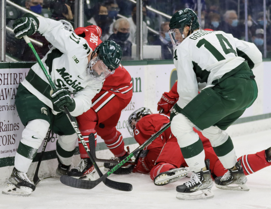 MSU forwards Kyle Haskins (17) and Adam Goddsir try to corral the loss puck against Ohio State on Jan. 21, 2022/ Photo Credit: Sarah Smith/WDBM