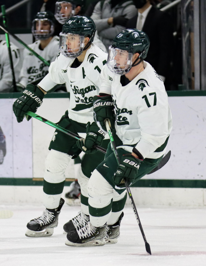 MSU+forwards+Kyle+Haskins+%2817%29+and+Adam+Goodsir+%2814%29+skate+to+the+puck+during+the+Spartans+3-2+loss+to+Ohio+State+on+Jan.+22%2C+2022%2F+Photo+Credit%3A+Sarah+Smith%2FWDBM