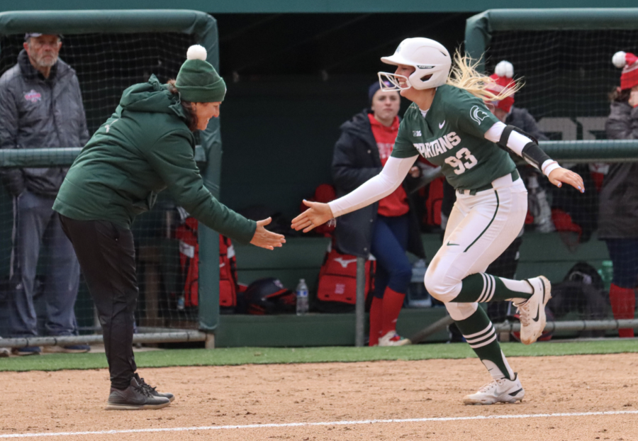 MSU infielder Kayleigh Roper high-fives Jacquie Joseph after hitting a home run during the Spartans victory over Detroit Mercy on March 29, 2022/ Photo Credit: Sarah Smith/WDBM
