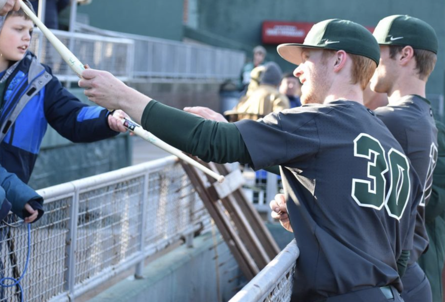 MSU pitcher Kyle Dunning signs a bat before the Spartans take on the Lansing Lugnuts on April 6, 2022/ Photo Credit: MSU Athletic Communications 