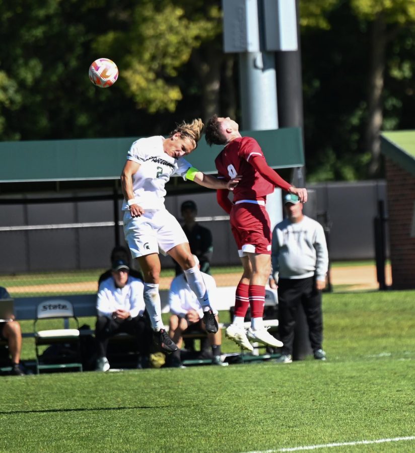 Jack Beck jumps up in the air for a header in Michigan States 1-0 win over Wisconsin on October 2, 2022. Photo Credit: Jack Moreland/WDBM