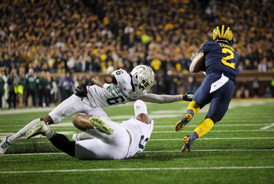 Two MSU defenders attempt to tackle Michigan running back Blake Corum on Oct. 29, 2022/ Photo credit: Sarah Smith