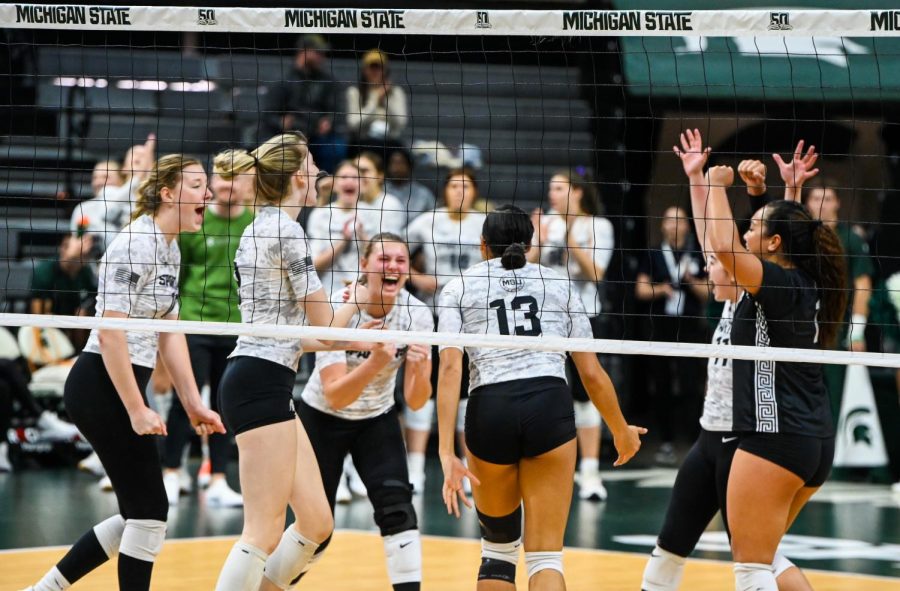 Michigan State teammates celebrate after a point during the Spartans match against Illinois on November 11, 2022. Photo Credit: Jack Moreland/WDBM