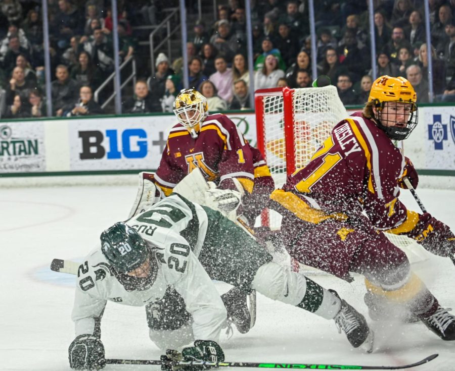 Daniel+Russell+lunges+for+the+puck+during+Michigan+States+loss+to+Minnesota+on+December+2%2C+2022.+Photo+Credit%3A+Jack+Moreland%2FWDBM