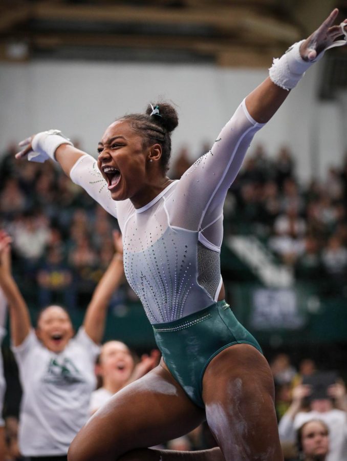 Olivia Zsarmani celebrates after her bar routine during Michigan States 197.200-196.975 victory over No. 3 Michigan on January 22, 2023. Photo Credit: Sarah Smith/WDBM