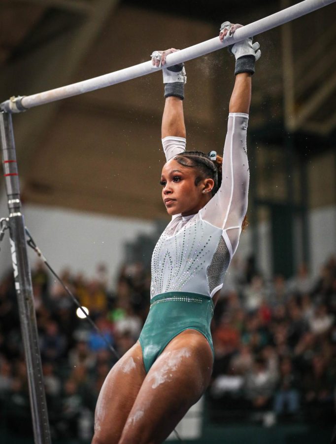 Nikki Smith performs her uneven bars routine during Michigan States 197.200-196.975 victory over No. 3 Michigan on January 22, 2023. Photo Credit: Sarah Smith/WDBM
