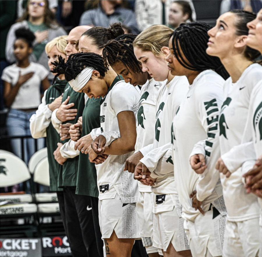 The+Michigan+State+Spartans+stand+for+the+national+anthem+before+their+win+against+Rutgers+on+January+22%2C+2023.+Photo+Credit%3A+Jack+Moreland%2FWDBM