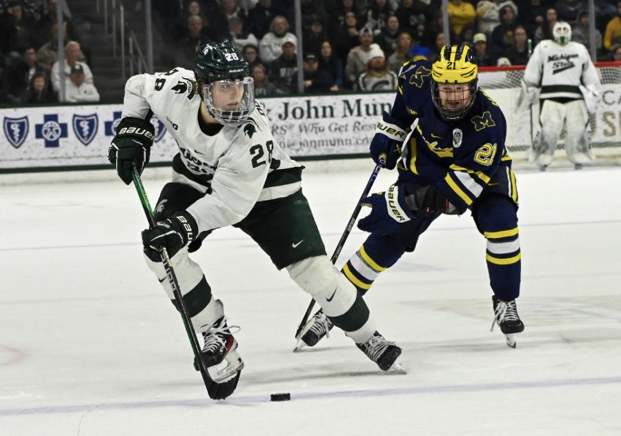 Karsen+Dorwart+gets+the+puck+past+a+Wolverine+defender+during+Michigan+State%E2%80%99s+4-2+loss+to+Michigan+on+February+10%2C+2023.+Photo+Credit%3A+Jack+Moreland%2FWDBM