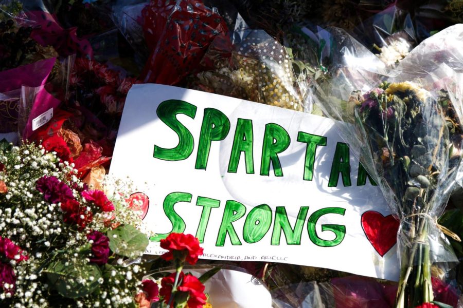 Spartan Strong sign placed among flower bouquets on MSUs campus. Photo Credit: Jake Rhodes/WDBM