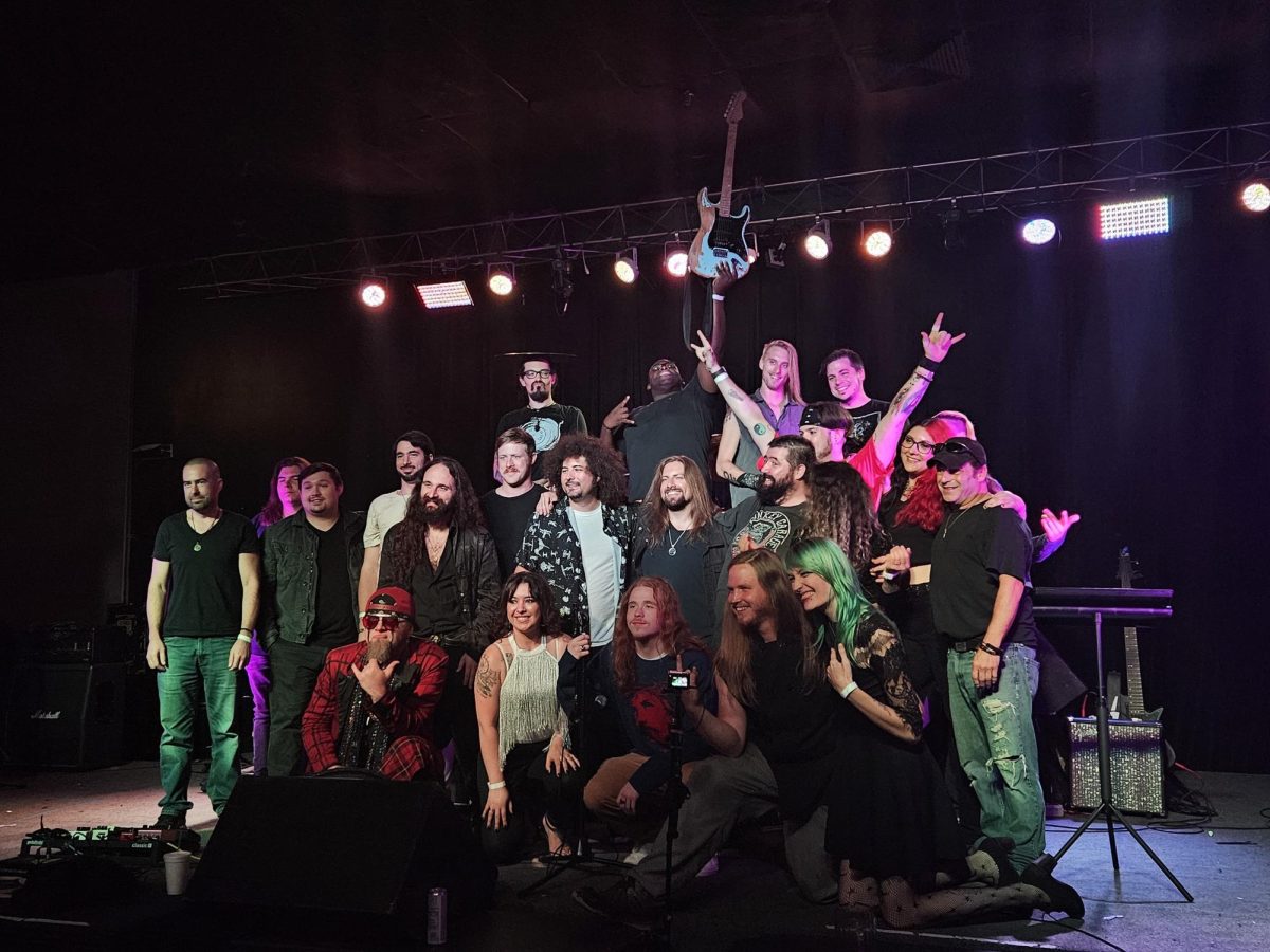 Members of The Amalgamation Project posing for a finale photo on-stage.