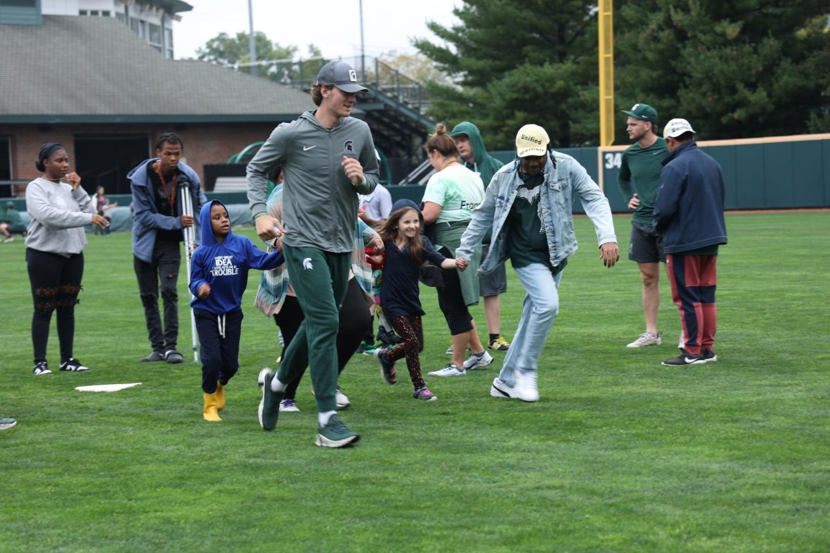 MSU baseball player takes off running the bases with the Beautiful Lives participants. Photo Credit: Mia Nishanian/WDBM