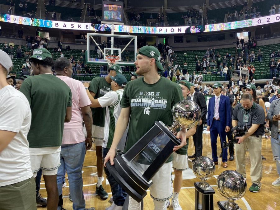 Kyle Ahrens poses with the Big Ten regular season title on Sunday, March 8, 2020. (Credit: Julian Mitchell / WDBM)