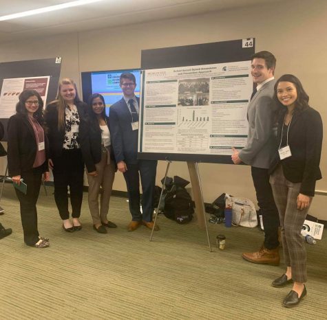 Britany, Basma and Christian presenting a poster