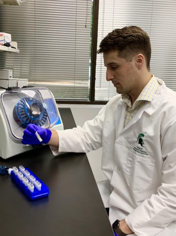 Zachary Morehouse in the laboratory with samples