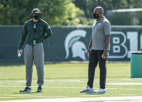 Mel Tucker talks with offensive coordinator Jay Johnson/Photo Credit: MSU Athletic Communications