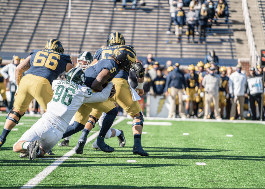 Jacub Panasiuk wraps up Michigan QB Joe Milton/ Photo Credit: MSU Athletic Communications
