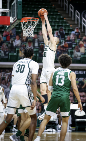 Joey Hauser forces a putback against Eastern Michigan/ Photo Credit: MSU Athletic Communications
