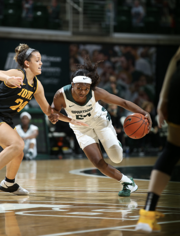 Nia Clouden dribbles past Iowa G Gabbie Marshall/ Photo Credit: MSU Athletic Communications
