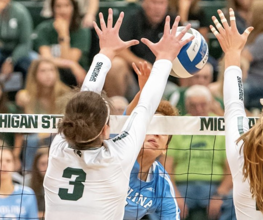 MSU+outside+hitter+Meredith+Norris+attempts+to+deflect+a+spike+during+a+game%2F+Photo+Credit%3A+MSU+Athletic+Communications%0A%0A