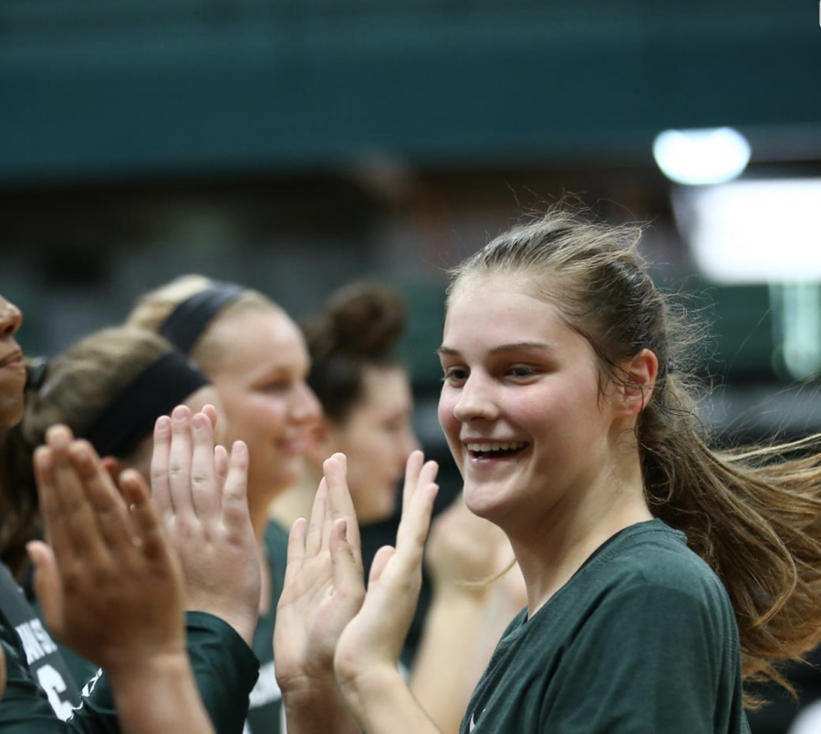 Molly+Johnson+high-fives+her+teammates%2F+Photo+Credit%3A+MSU+Athletic+Communications%0A