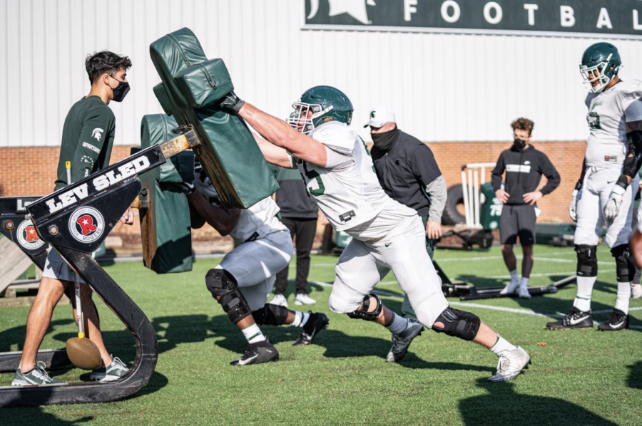 MSU+offensive+line+coach+Chris+Kapilovic+supervises+a+sled-driving+drill+during+2021+spring+practice%2F+Photo+Credit%3A+MSU+Athletic+Communications+%0A%0A%0A%0A%0A%0A%0A%0A