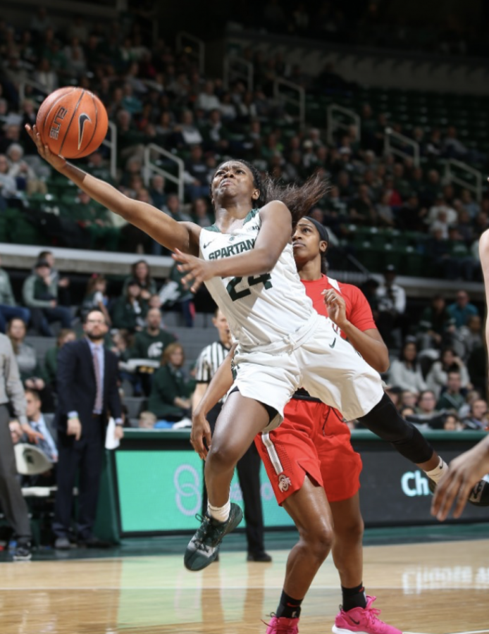 MSU head coach Nia Clouden drives for a contested layup against Ohio State/ Photo Credit: MSU Athletic Communications 