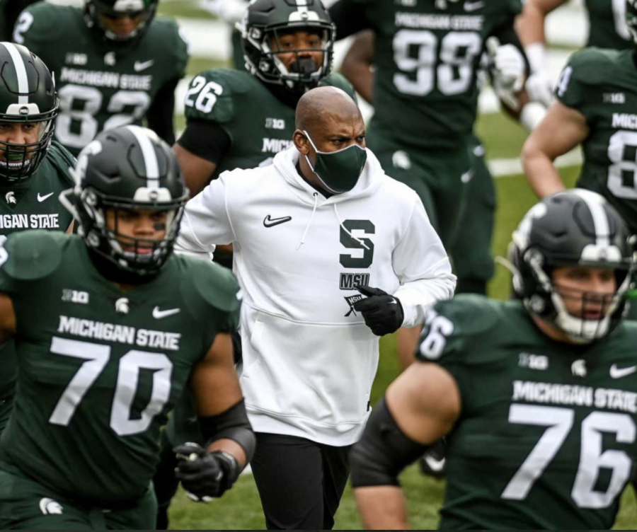 MSU+head+coach+Mel+Tucker+runs+out+of+the+tunnel+with+his+team+before+a+game%2F+Photo+Credit%3A+MSU+Athletic+Communications+%0A