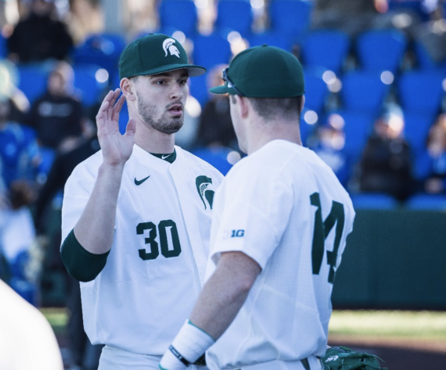 MSU+pitcher+Mason+Erla+high-fives+teammate+Andrew+Morrow%2F+Photo+Credit%3A+MSU+Athletic+Communications+%0A%0A%0A