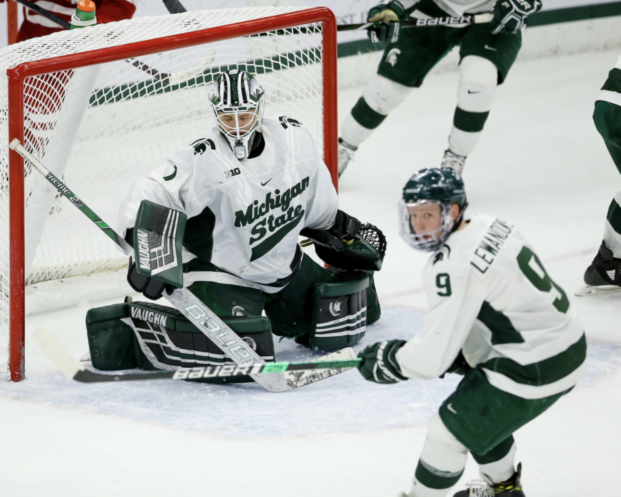 MSU goaltender Drew DeRidder glances at a flying puck during a game in 2020/ Photo Credit: MSU Athletic Communications 