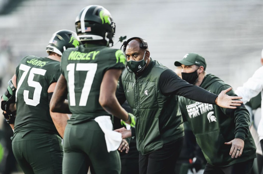 MSU head coach Mel Tucker high-fives wide receiver Tre Mosley (17) and offensive lineman Kevin Jarvis (75)/ Photo Credit: MSU Athletic Communications 