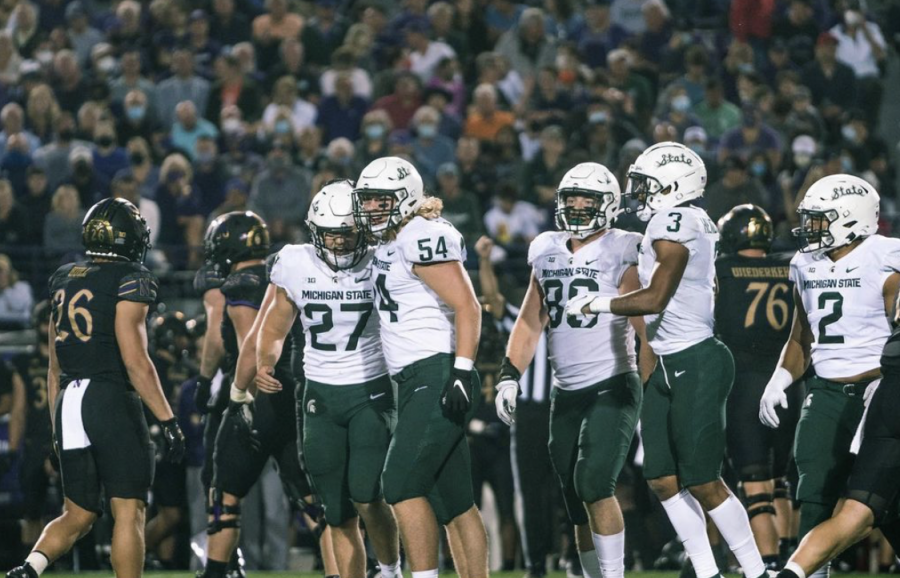 MSU defensive tackle Kyle King (54) and linebacker Cal Haladay (27) jog off the field in the Spartans' 38-21 season-opening win over Northwestern/ Photo Credit: MSU Athletic Communications 