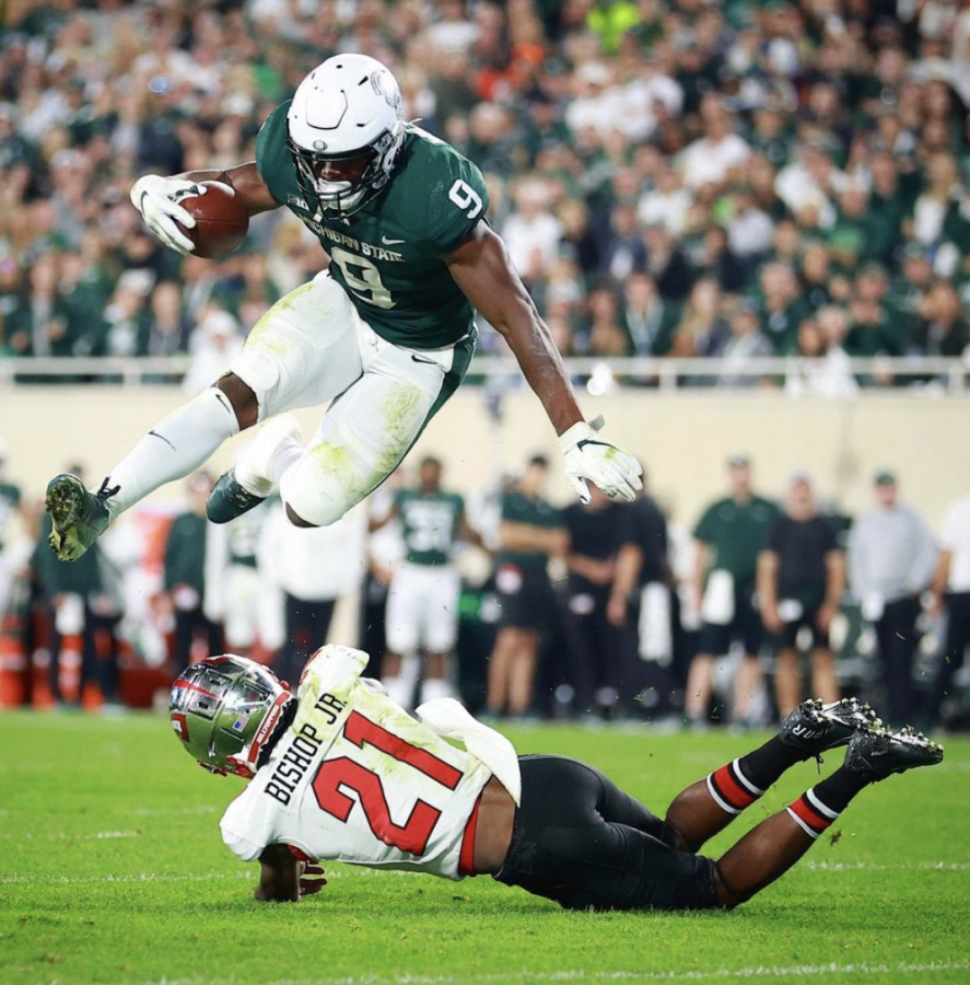 MSU+running+back+Kenneth+Walker+hurdles+Western+Kentucky+safety+Beanie+Bishop+in+the+Spartans+48-31+win+over+the+Hilltoppers+on+Oct.+2%2C+2021%2F+Photo+Credit%3A+MSU+Athletic+Communications+