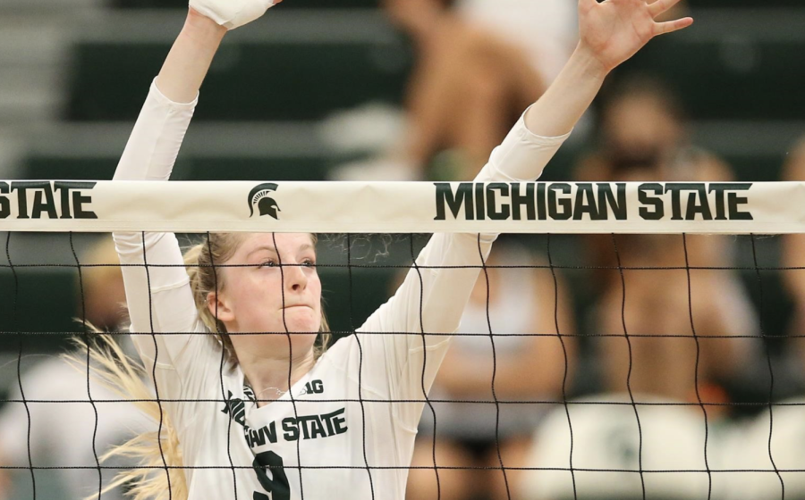 MSU middle blocker Emma Monks (9) guards the front of the net during a game in 2021/ Photo Credit: MSU Athletic Communications 