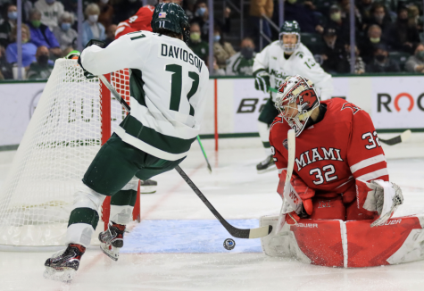 MSU forward Jeremy Davidson tries to corral a puck in front of the net during the Spartans 3-1 win over Miami (OH) on Oct. 16, 2021/ Photo Credit: Sarah Smith/WDBM