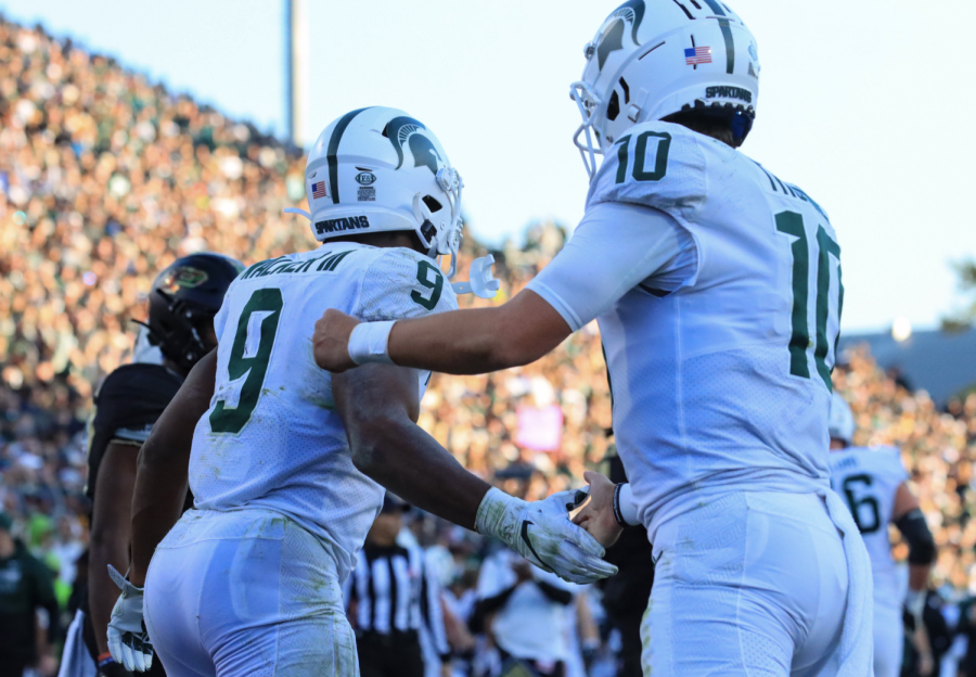 MSU quarterback Payton Thorne congratulates running back Kenneth Walker after Walker runs for a touchdown against Purdue on Nov. 6, 2021/ Photo Credit: Sarah Smith/WDBM