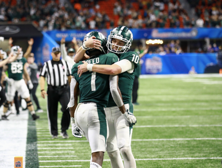 MSU quarterback Payton Thorne hugs wide receiver Jayden Reed after Reed's 22-yard go-ahead touchdown catch in the 2021 Peach Bowl/ Photo Credit: Sarah Smith/WDBM
