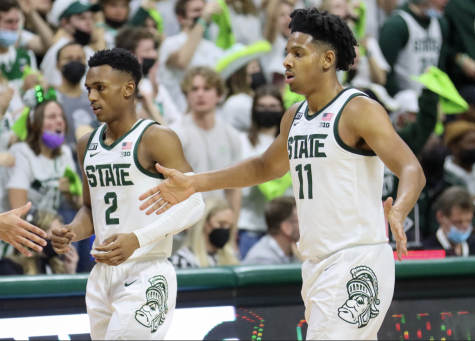 MSU point guard A.J. Hoggard and Tyson Walker high-five their teammates during the Spartans 68-65 win over No. 4 Purdue on Feb. 26, 2022/ Photo Credit: Sarah Smith/WDBM
