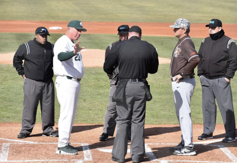 MSU coach Jake Boss hands his lineup card to an umpire before the Spartans take on Bowling Green on March 29, 2022/ Photo Credit: MSU Athletic Communications
