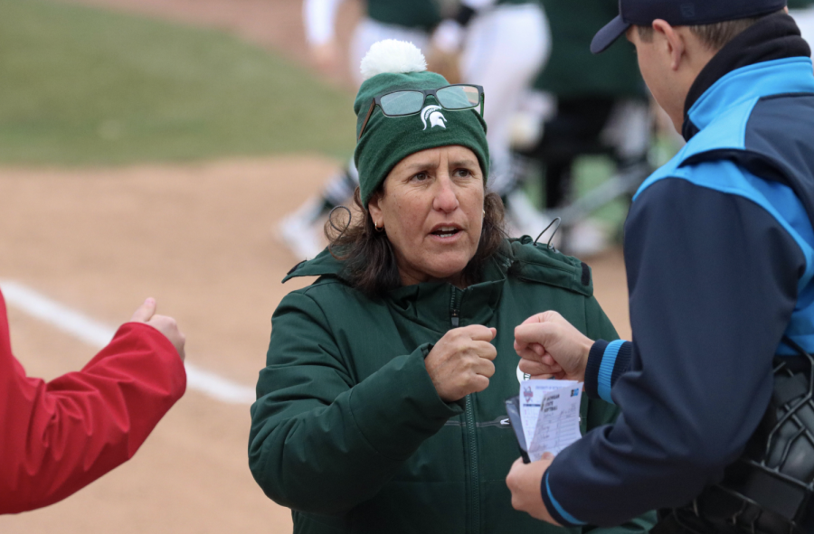 MSU softball head coach Jacquie Joseph fist-bumps an umpire before the Spartans doubleheader sweep over Detroit Mercy on March 29, 2022/ Photo Credit: Sarah Smith/WDBM
