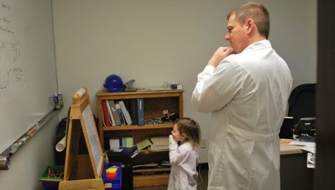 Gregory Hess doing research with a child